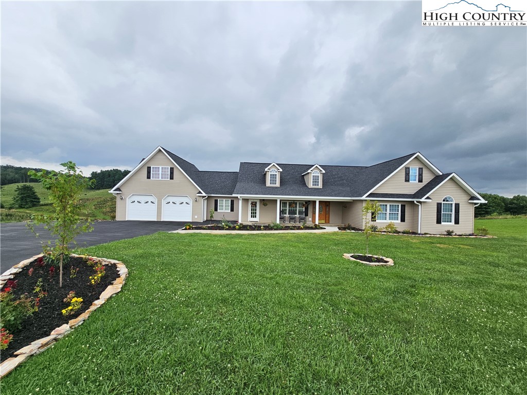 611 Barrett Road Ennice, NC 28623 - Photo 9 of 45 a view of a big house with a big yard potted plants and large tree