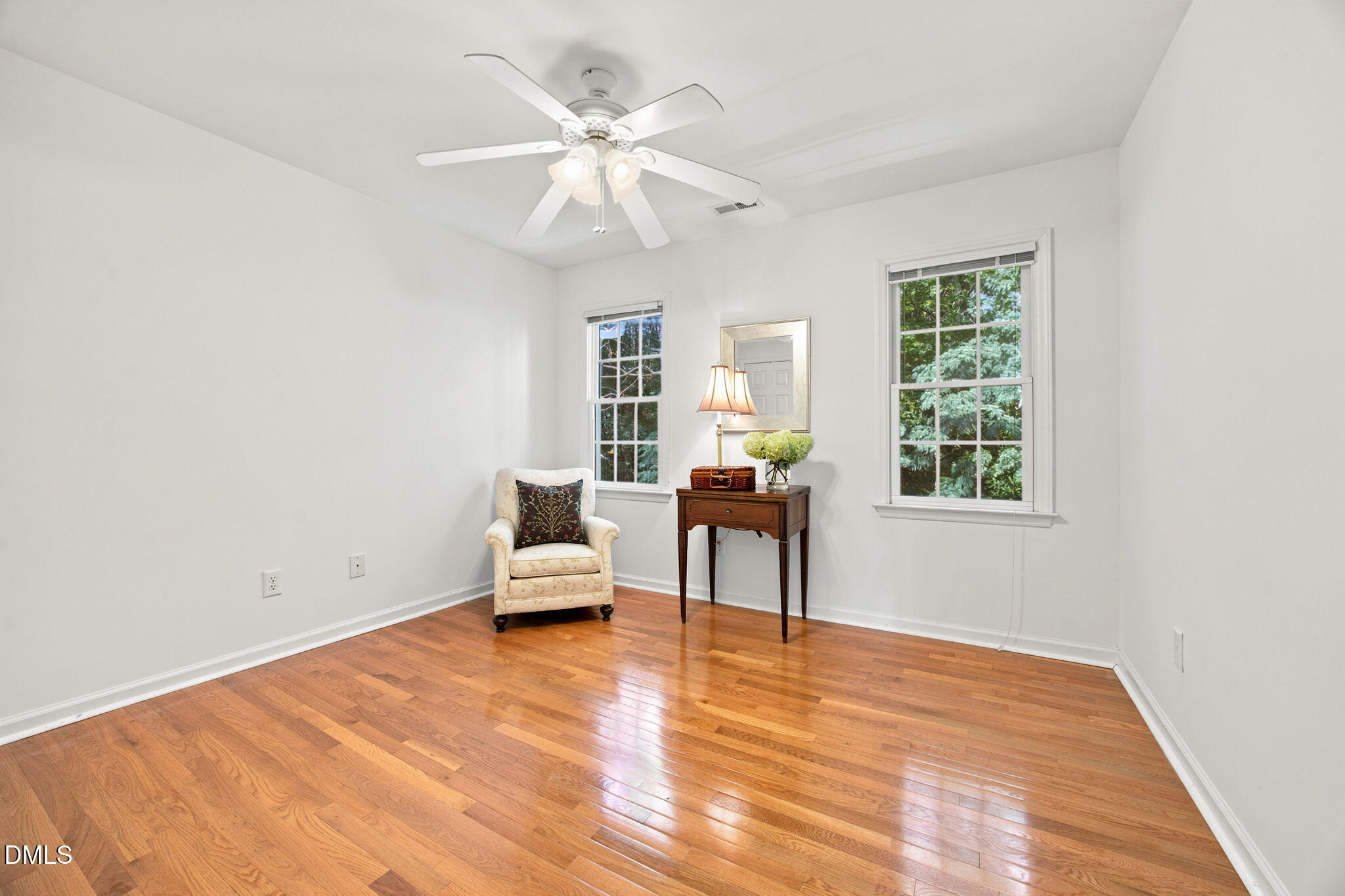 8211 Hempshire Place, Unit 104 Raleigh, NC 27613 - Photo 26 of 34 Spacious room featuring hardwood flooring, white walls, and bright white trim