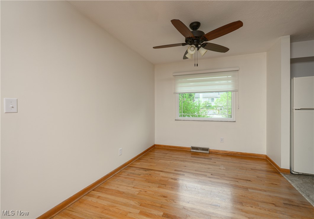 2783 Shellhart Road Barberton, OH 44203 - Photo 12 of 24 Unfurnished bedroom with freestanding refrigerator, light wood finished floors, and a ceiling fan
