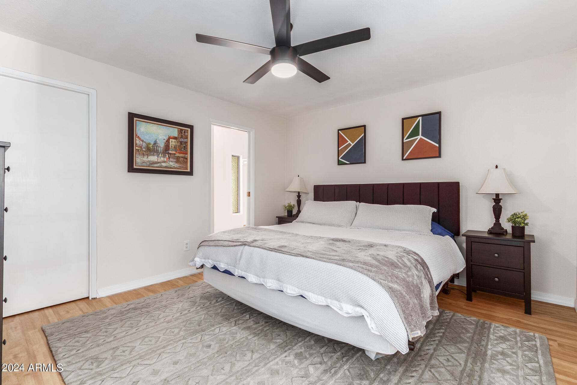 4950 North Miller Road, Unit 347 Scottsdale, AZ 85251 - Photo 13 of 31 a spacious bedroom with a bed and a chandelier