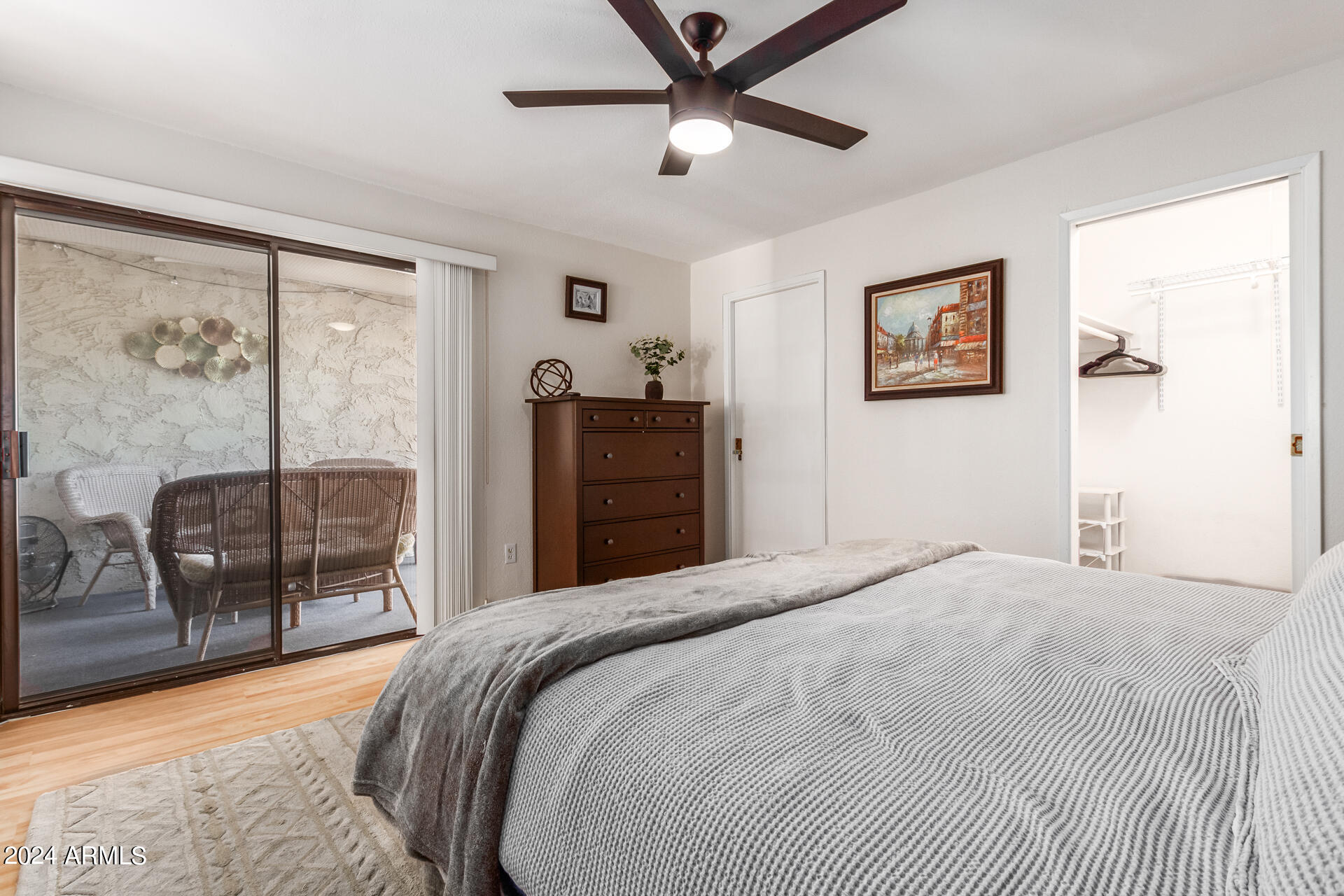4950 North Miller Road, Unit 347 Scottsdale, AZ 85251 - Photo 15 of 31 a bedroom with a large bed and a chandelier