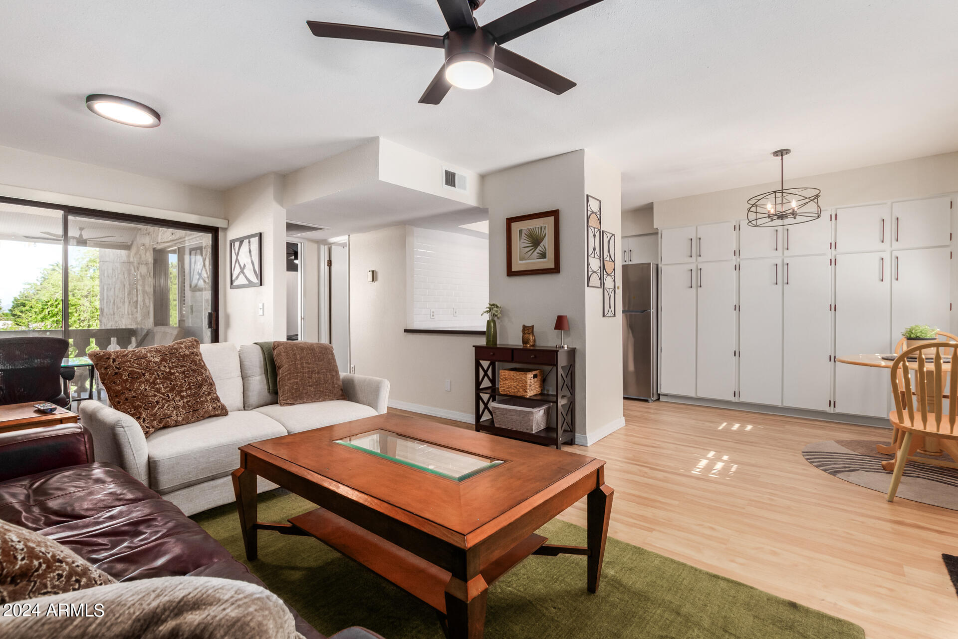4950 North Miller Road, Unit 347 Scottsdale, AZ 85251 - Photo 16 of 31 a living room with furniture a ceiling fan and a rug