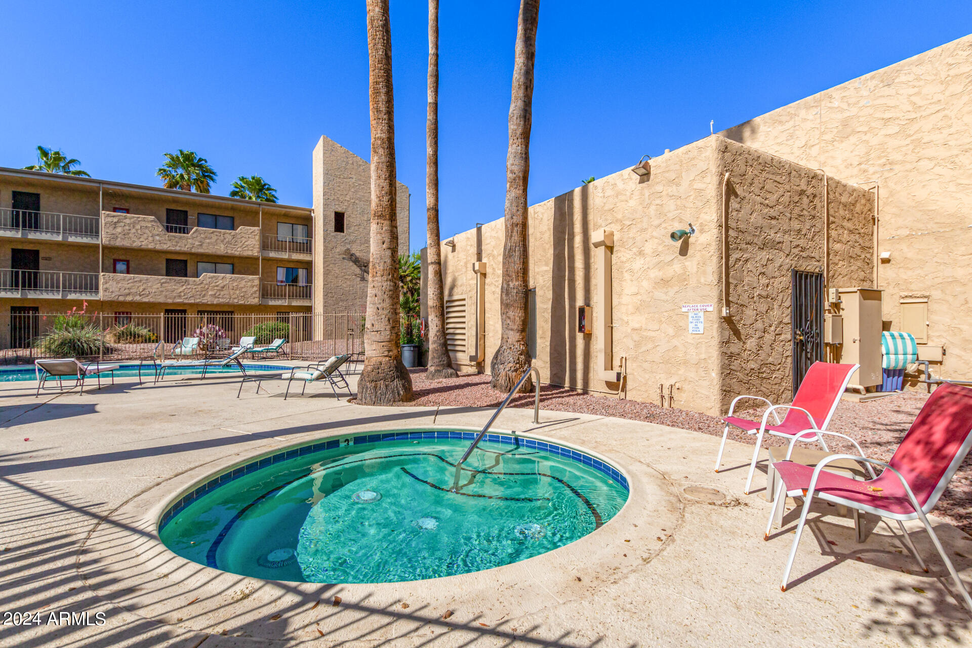 4950 North Miller Road, Unit 347 Scottsdale, AZ 85251 - Photo 23 of 31 a swimming pool with outdoor seating and yard