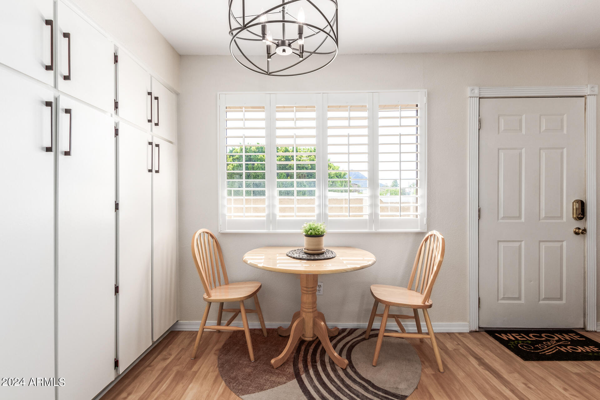 4950 North Miller Road, Unit 347 Scottsdale, AZ 85251 - Photo 7 of 31 a dining room with furniture a rug and wooden floor