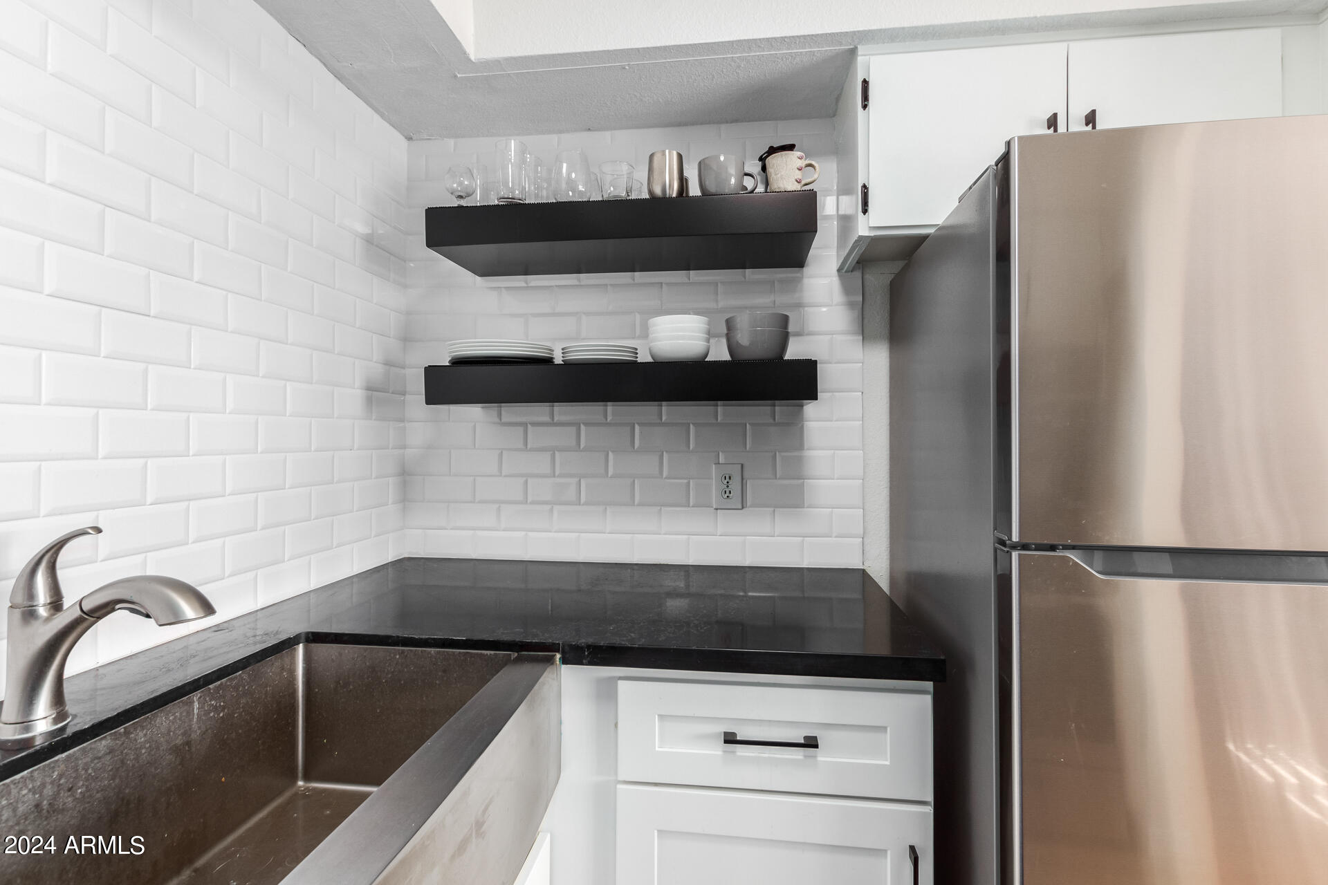 4950 North Miller Road, Unit 347 Scottsdale, AZ 85251 - Photo 10 of 31 a kitchen with a refrigerator and a sink