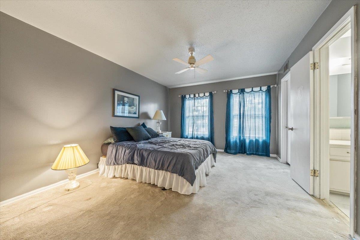875 South Yates Road, Unit 4 Memphis, TN 38120 - Photo 17 of 25 Carpeted bedroom featuring a textured ceiling and ceiling fan
