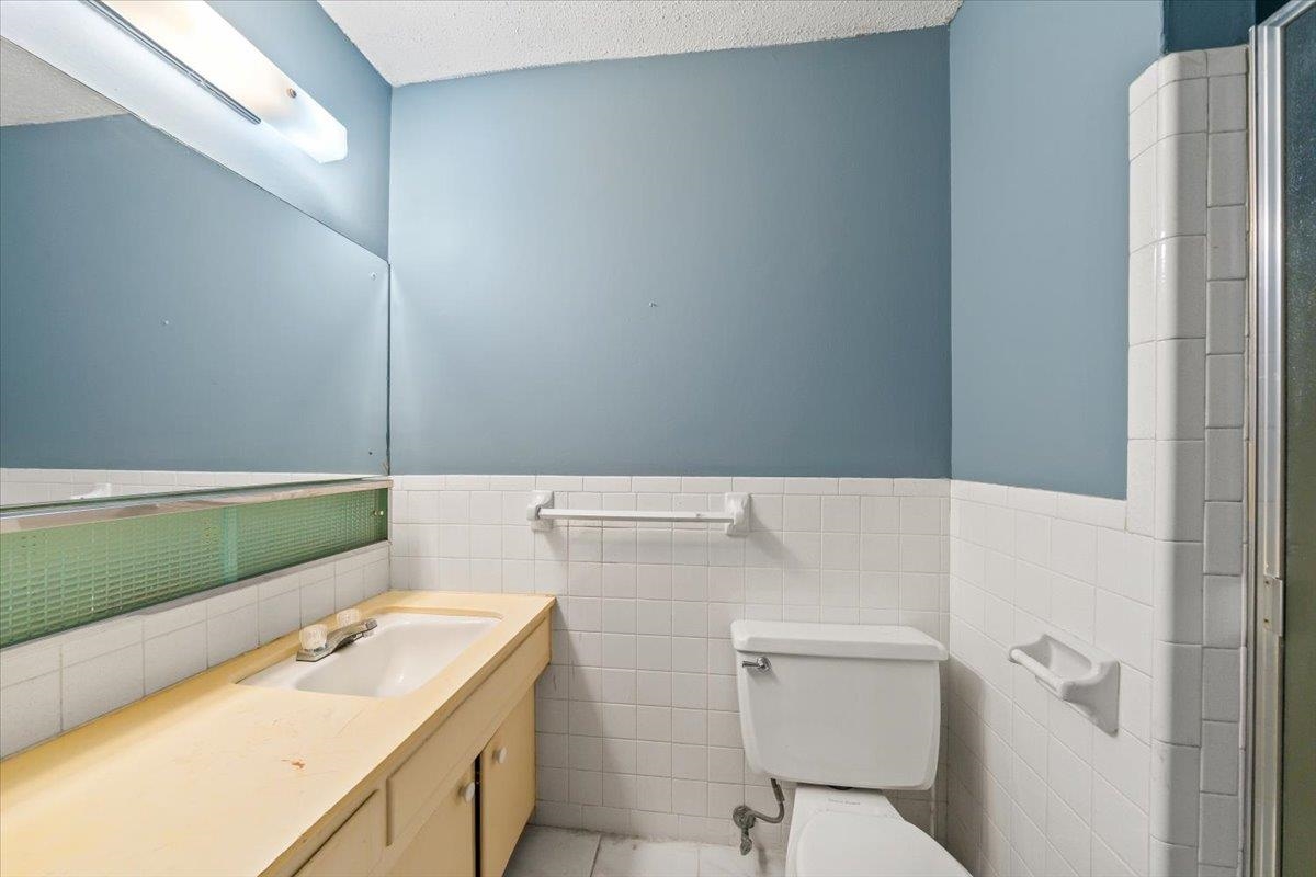 875 South Yates Road, Unit 4 Memphis, TN 38120 - Photo 24 of 25 Bathroom with vanity, tile walls, a wainscoted wall, and tile patterned flooring