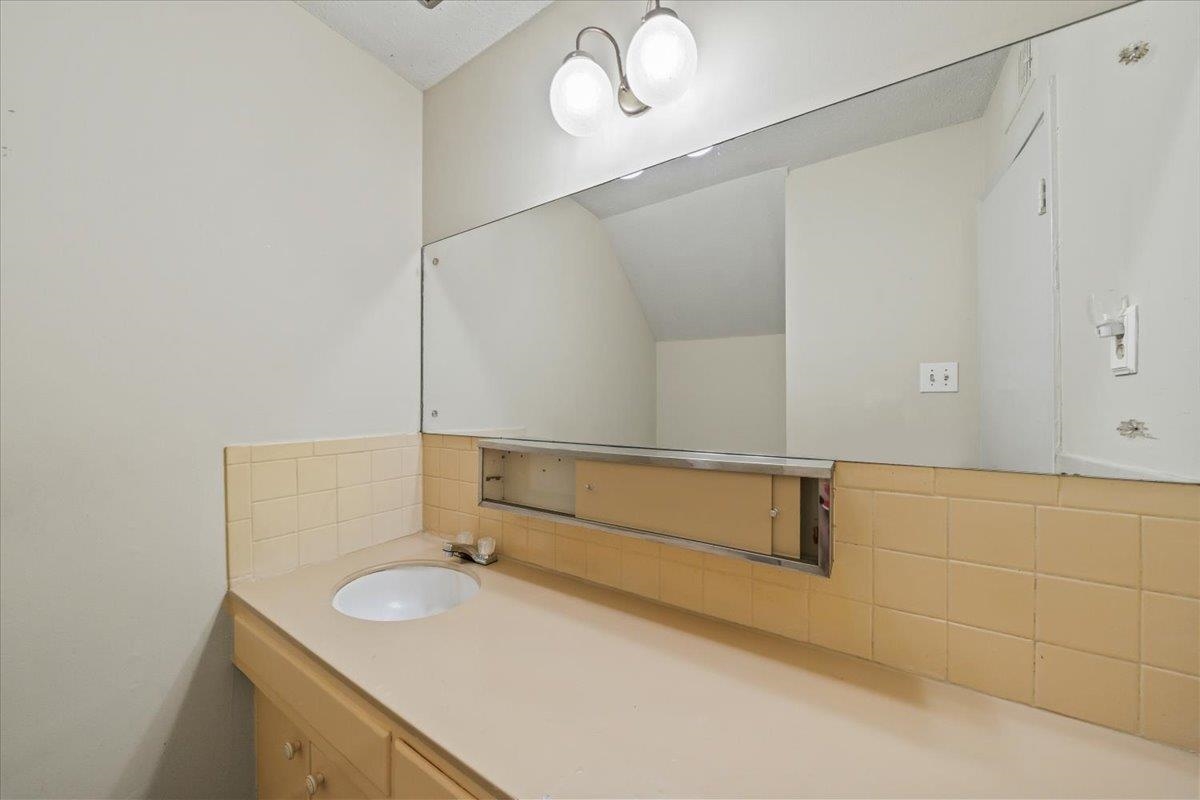 875 South Yates Road, Unit 4 Memphis, TN 38120 - Photo 25 of 25 Bathroom featuring a sink and tasteful backsplash