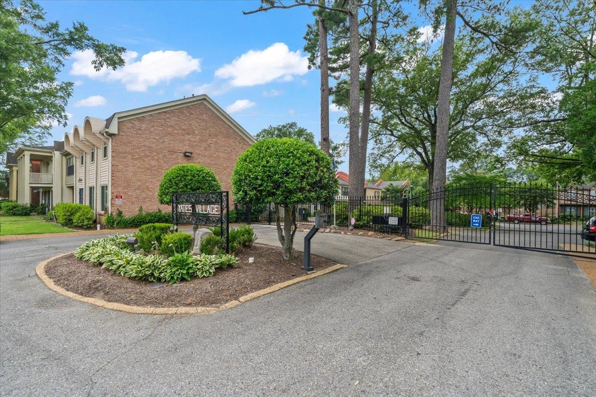 875 South Yates Road, Unit 4 Memphis, TN 38120 - Photo 3 of 25 View of asphalt street featuring a gate and a gated entry