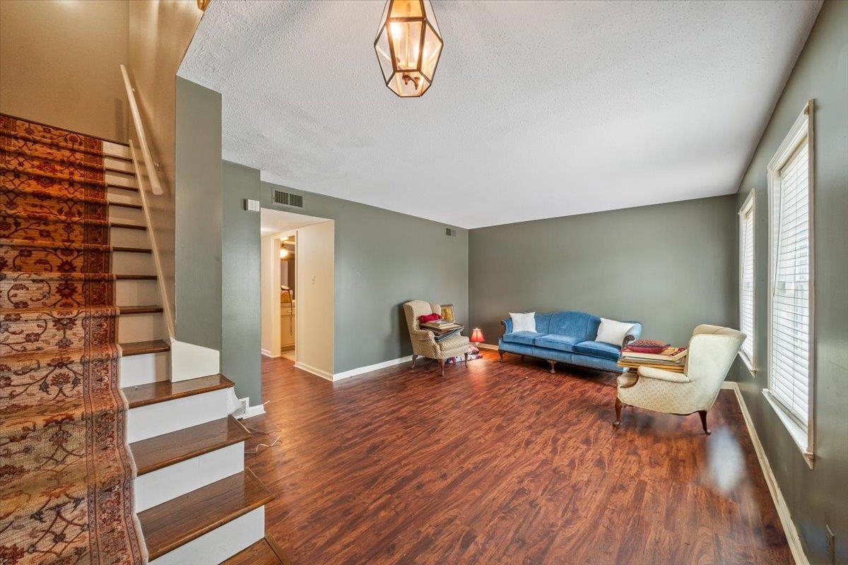875 South Yates Road, Unit 4 Memphis, TN 38120 - Photo 7 of 25 Living area featuring stairs, wood finished floors, and a textured ceiling