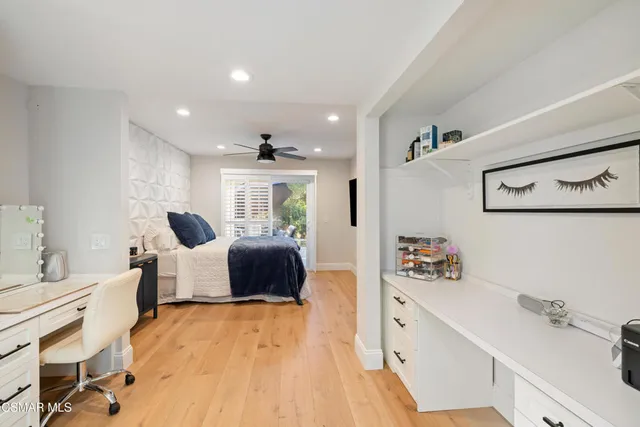 a living room with furniture and a dresser