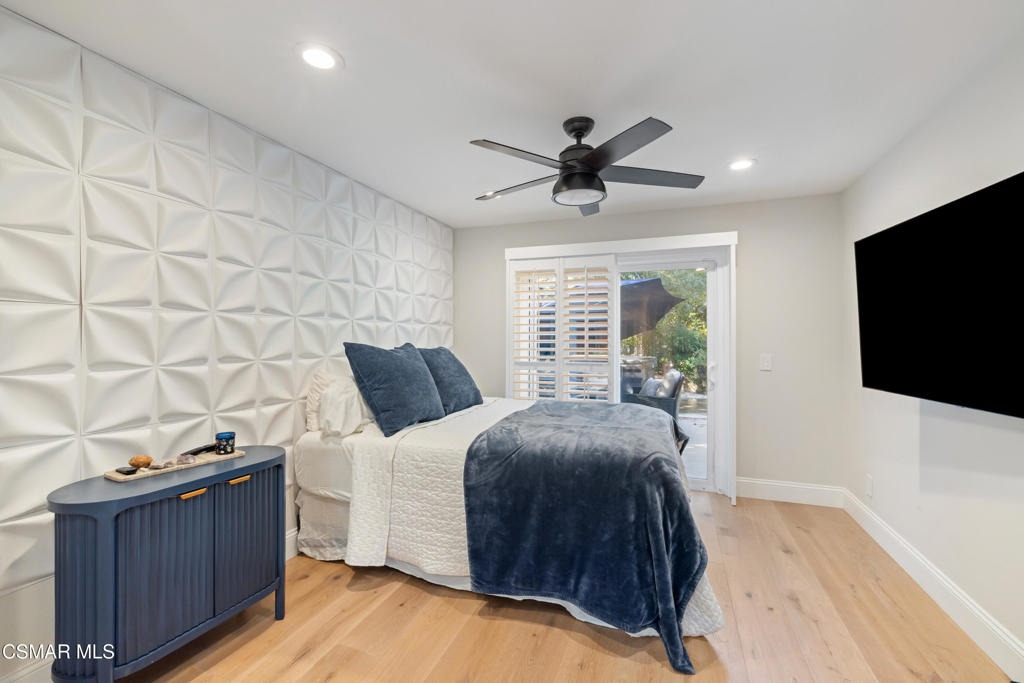 885 Rim Crest Drive Westlake Village, CA 91361 - Photo 12 of 35 a spacious bedroom with a bed and a flat screen tv