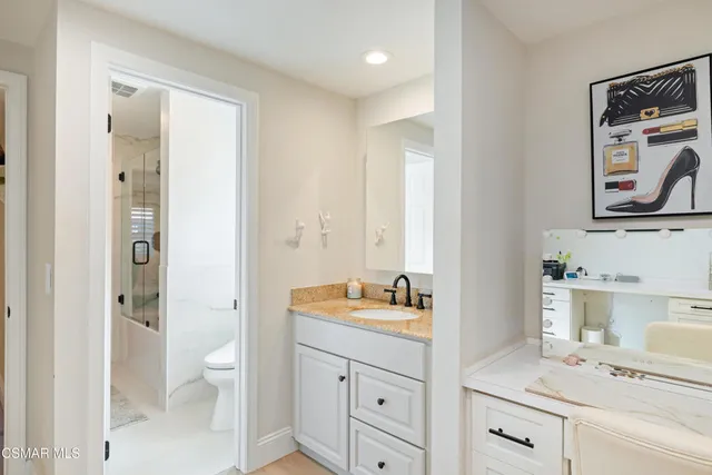 a spacious bathroom with a double vanity sink a mirror and a shower