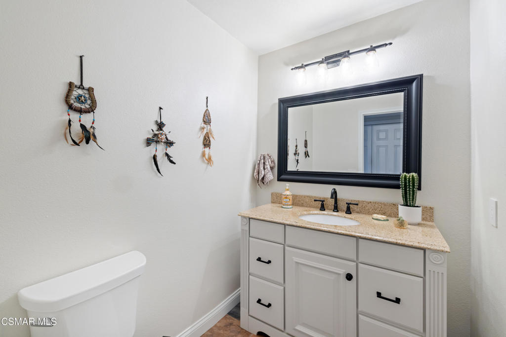 885 Rim Crest Drive Westlake Village, CA 91361 - Photo 17 of 35 a bathroom with a toilet sink and mirror