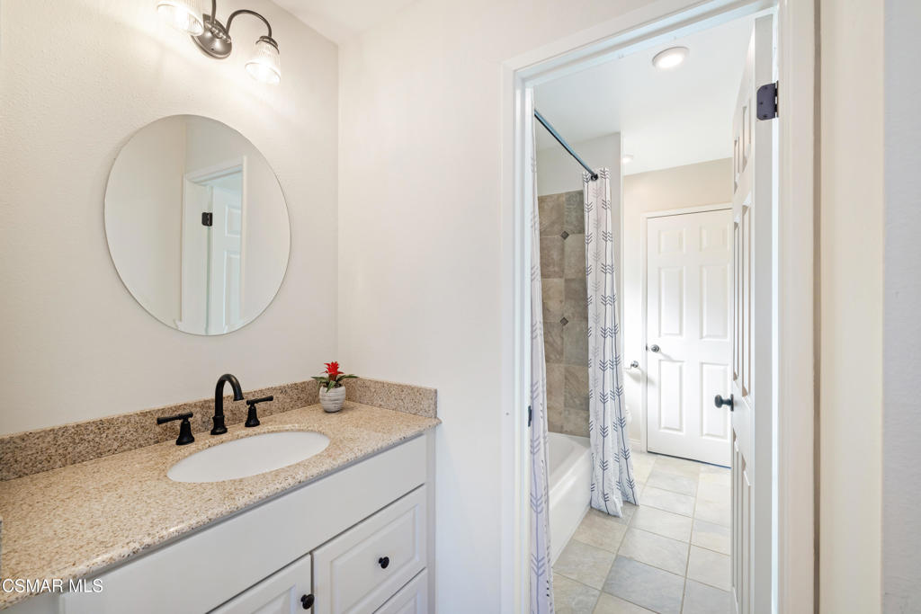885 Rim Crest Drive Westlake Village, CA 91361 - Photo 23 of 35 a en suite bathroom with a granite countertop sink and a mirror