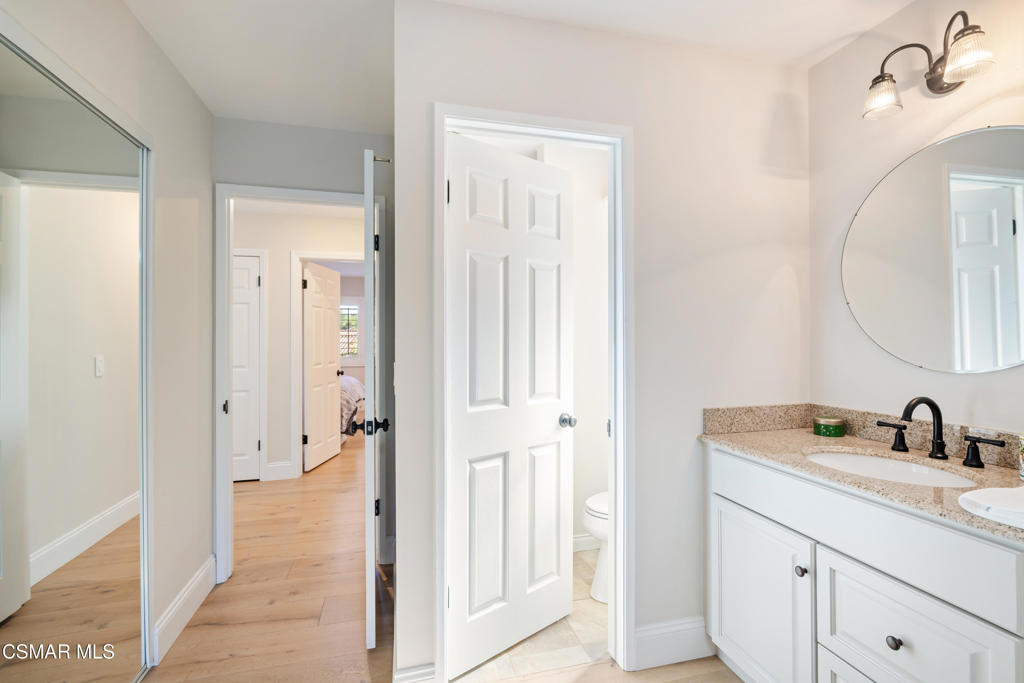 885 Rim Crest Drive Westlake Village, CA 91361 - Photo 24 of 35 a en suite bathroom with a sink a mirror and a shower