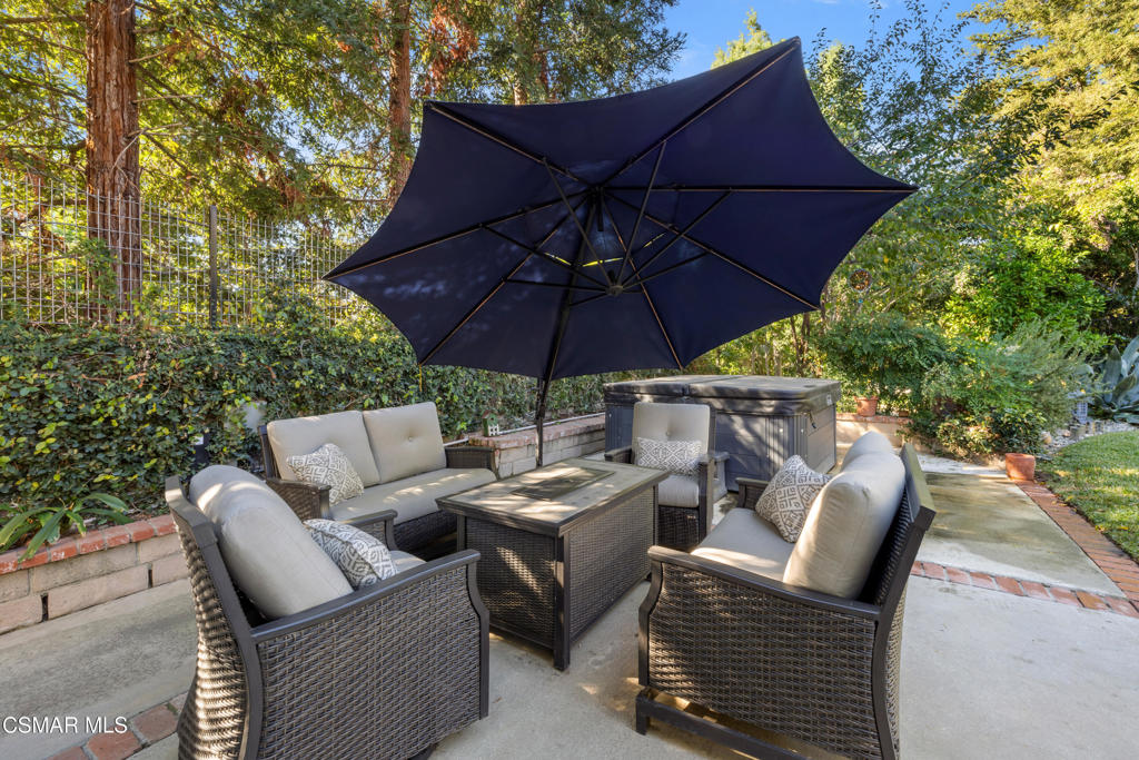 885 Rim Crest Drive Westlake Village, CA 91361 - Photo 31 of 35 a patio with patio a table and chairs under an umbrella