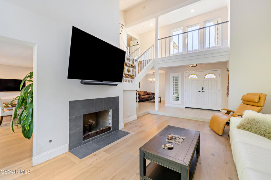 885 Rim Crest Drive Westlake Village, CA 91361 - Photo 4 of 35 a living room with furniture a flat screen tv and a fireplace
