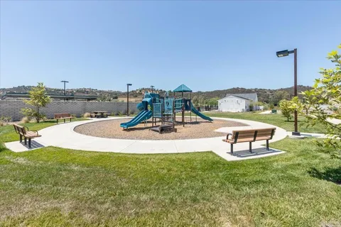 a swimming pool with outdoor seating and a garden