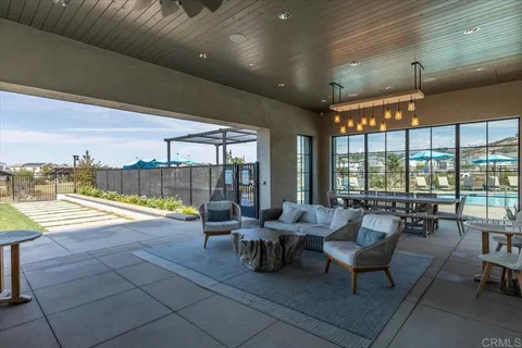 a swimming pool with outdoor seating and a patio