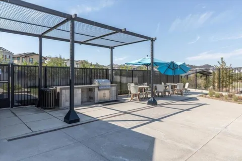 a view of a patio with a table and chairs