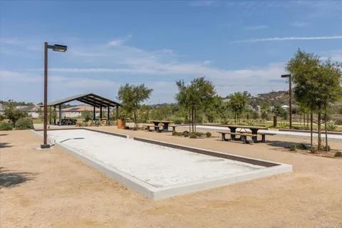 a view of a swimming pool with a yard and sitting area