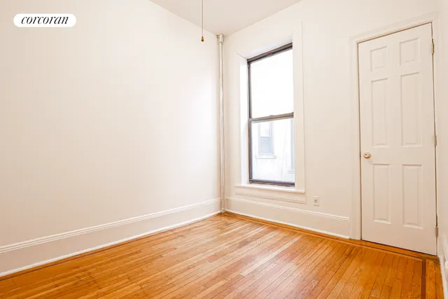 a view of a hallway with wooden floor and glass doors