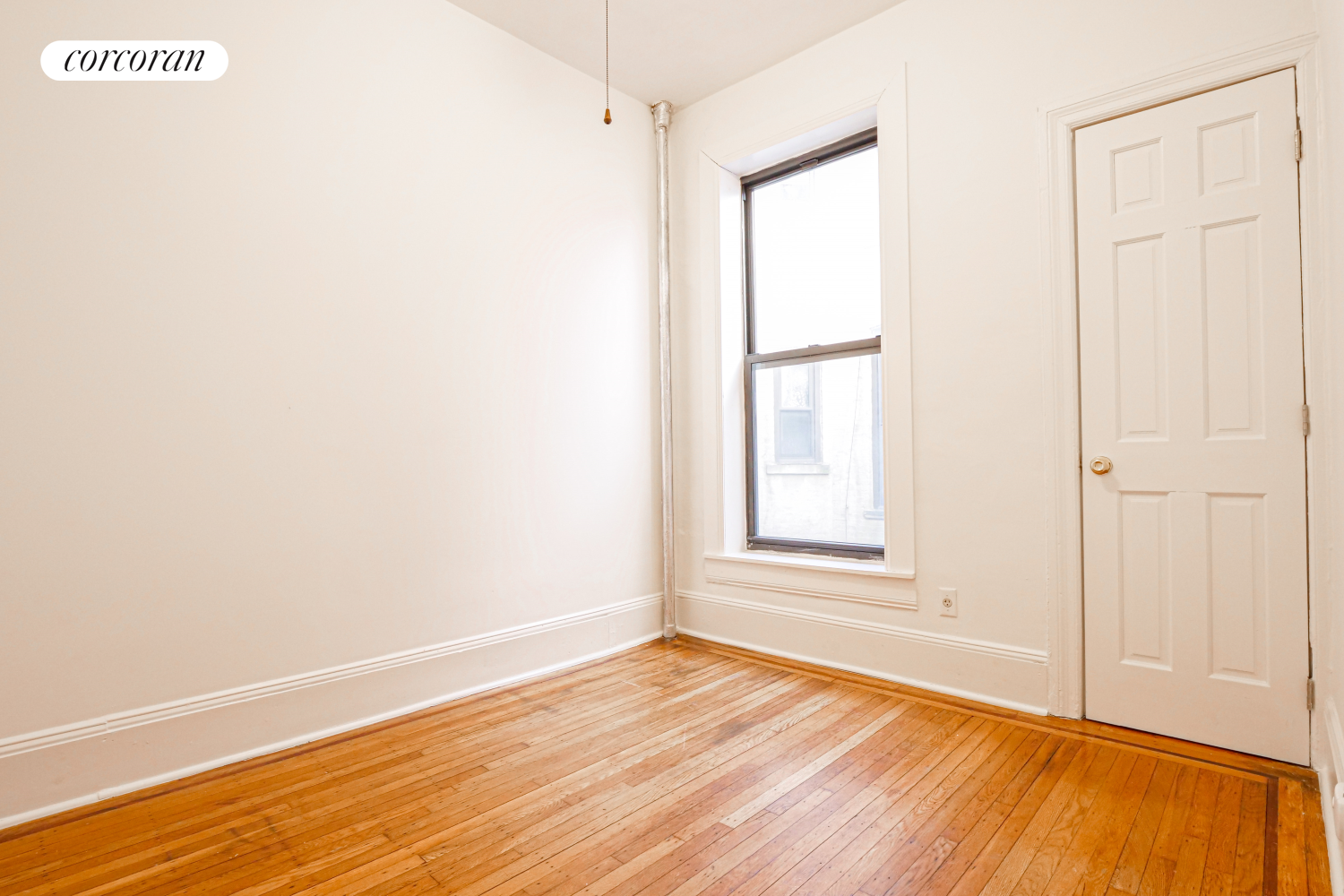 524 5th Street Brooklyn, NY 11215 - Photo 10 of 23 a view of an empty room with wooden floor and a window