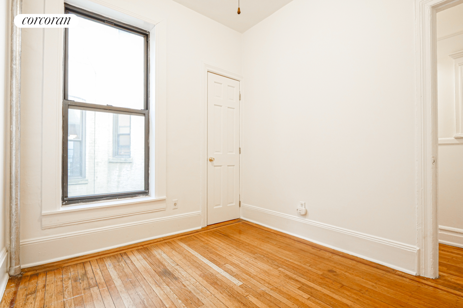 524 5th Street Brooklyn, NY 11215 - Photo 11 of 23 a view of empty room with wooden floor and fan