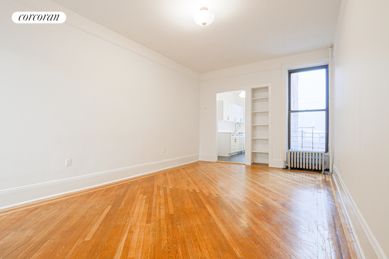 524 5th Street Brooklyn, NY 11215 - Photo 17 of 23 a view of an empty room with wooden floor and a window