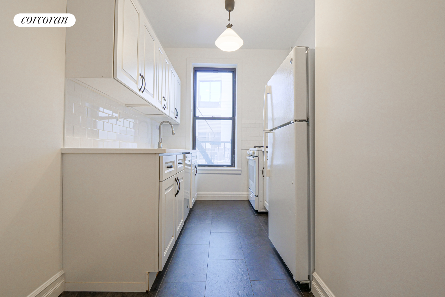 524 5th Street Brooklyn, NY 11215 - Photo 19 of 23 a kitchen with white cabinets and white appliances