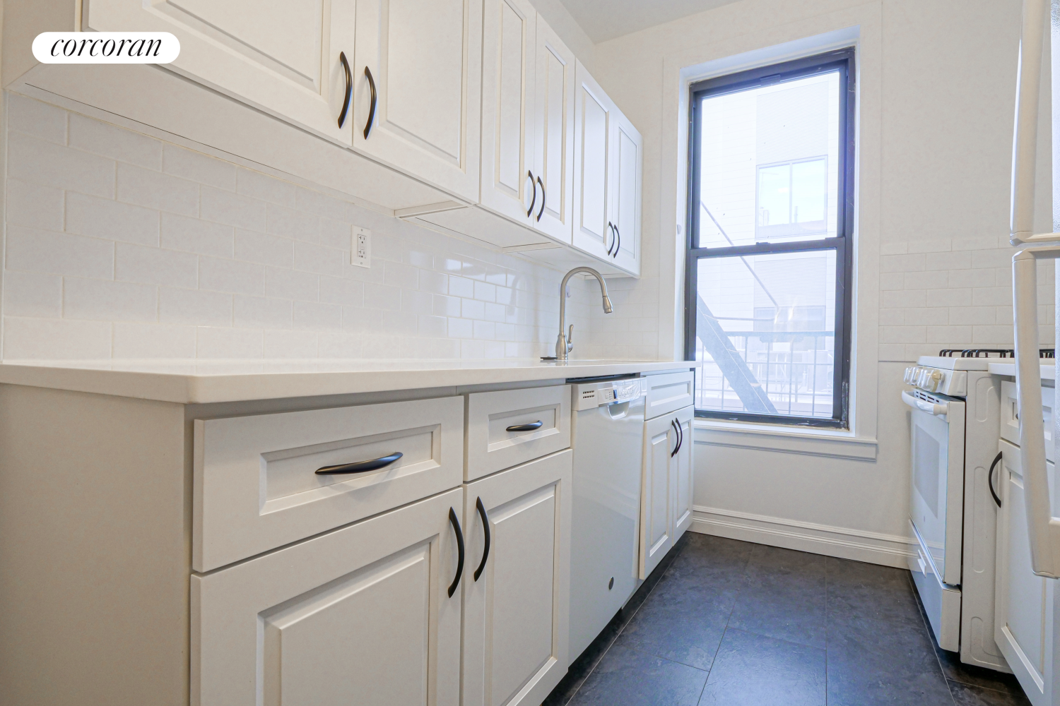 524 5th Street Brooklyn, NY 11215 - Photo 20 of 23 a kitchen with a white cabinets and a refrigerator