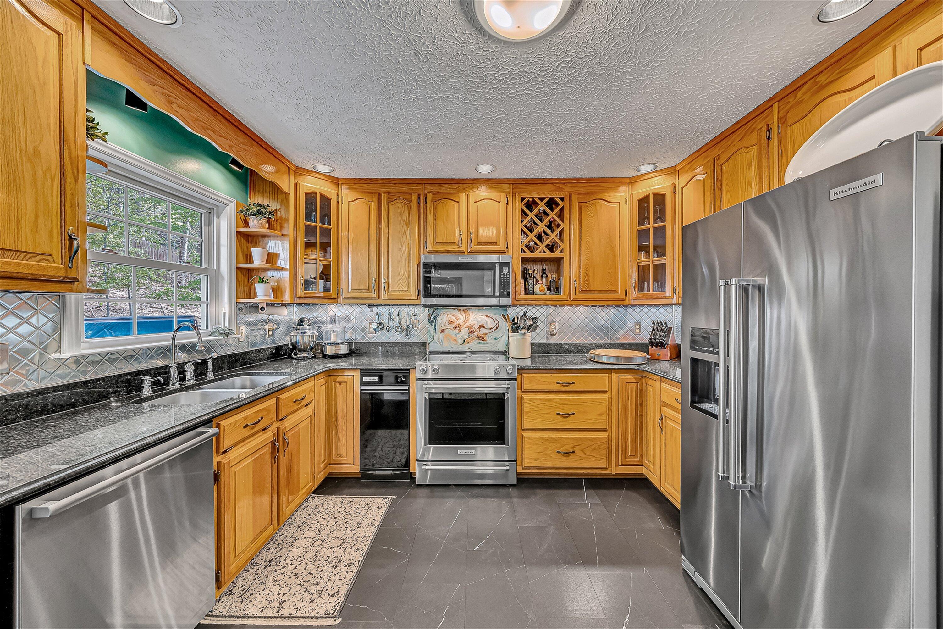 4723 Norwood Street Southwest Roanoke, VA 24018 - Photo 40 of 84 a kitchen with granite countertop a refrigerator stove and sink