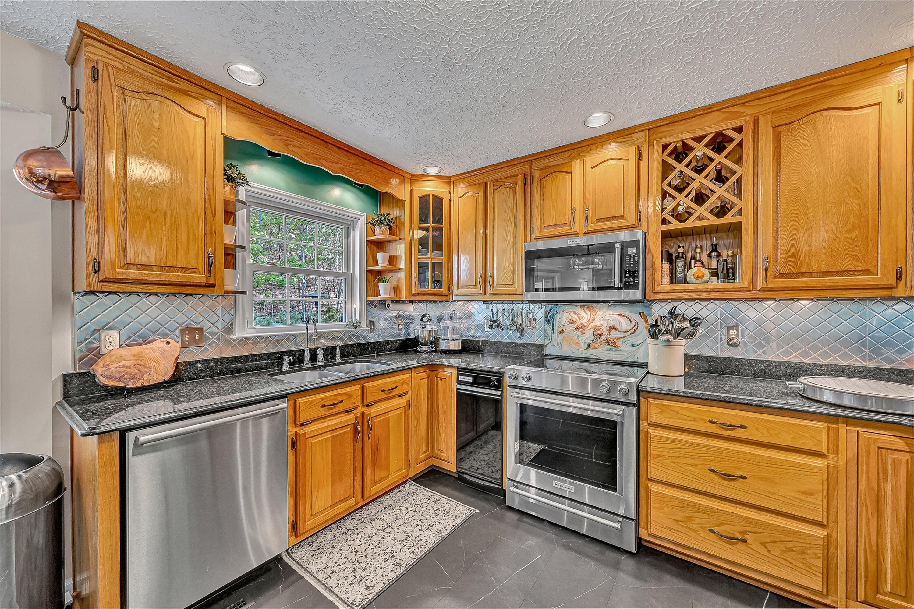 4723 Norwood Street Southwest Roanoke, VA 24018 - Photo 41 of 84 a kitchen with stainless steel appliances granite countertop a sink stove and cabinets