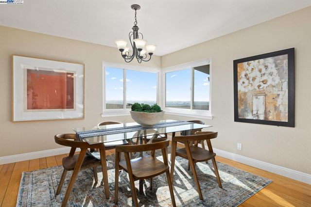 a view of a dining room with furniture wooden floor and a chandelier