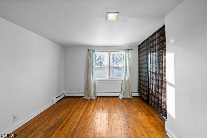 973 Ellis Parkway Edison, NJ 08820 - Photo 12 of 33 an empty room with wooden floor and windows