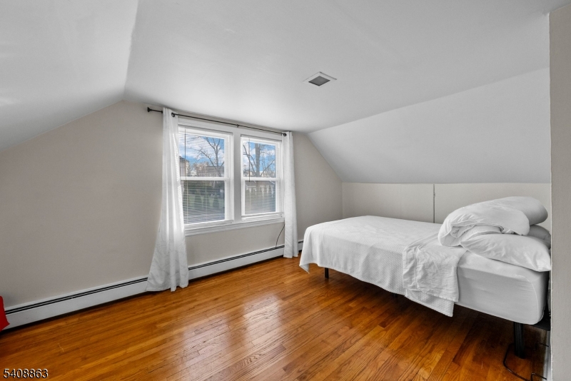 973 Ellis Parkway Edison, NJ 08820 - Photo 23 of 33 a bedroom with a bed and wooden floor