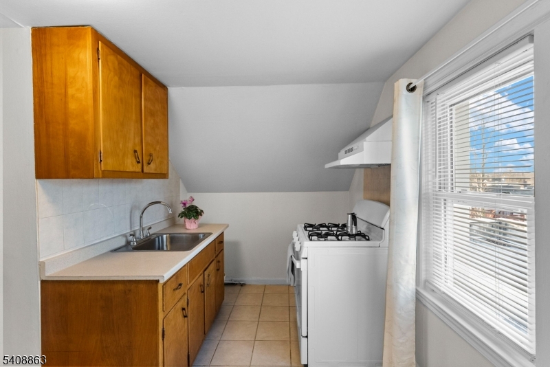 973 Ellis Parkway Edison, NJ 08820 - Photo 24 of 33 a kitchen with a sink a refrigerator and cabinets