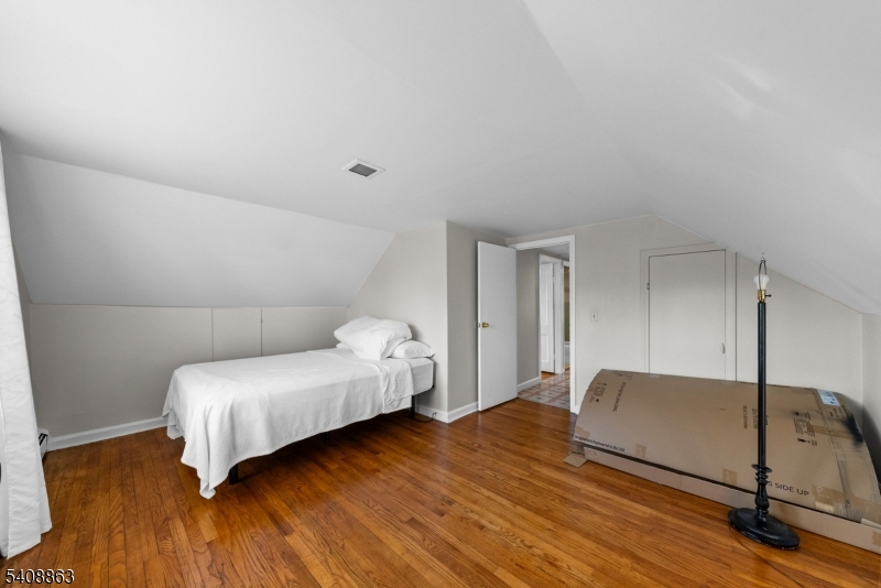 973 Ellis Parkway Edison, NJ 08820 - Photo 25 of 33 a bedroom with a bed and wooden floor