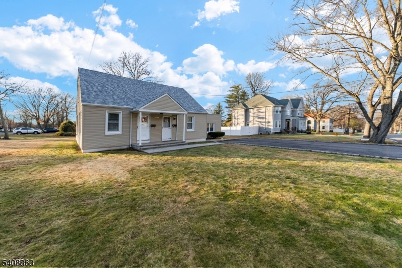 973 Ellis Parkway Edison, NJ 08820 - Photo 28 of 33 a front view of a house with a big yard and large trees