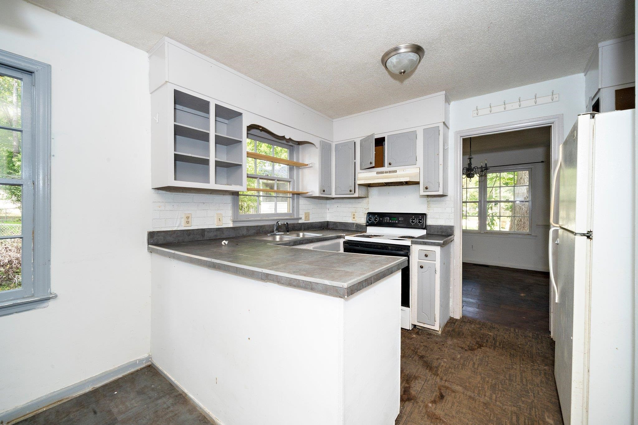 1307 Brookgreen Drive Cary, NC 27511 - Photo 15 of 26 a kitchen with stainless steel appliances granite countertop a stove and a sink