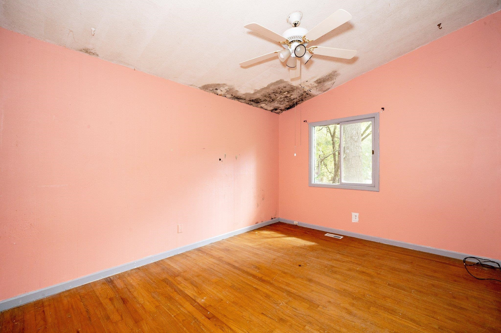 1307 Brookgreen Drive Cary, NC 27511 - Photo 20 of 26 an empty room with a window and a ceiling fan