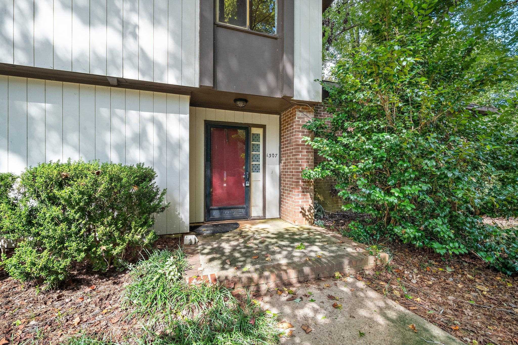 1307 Brookgreen Drive Cary, NC 27511 - Photo 2 of 26 a view of yellow house with a yard