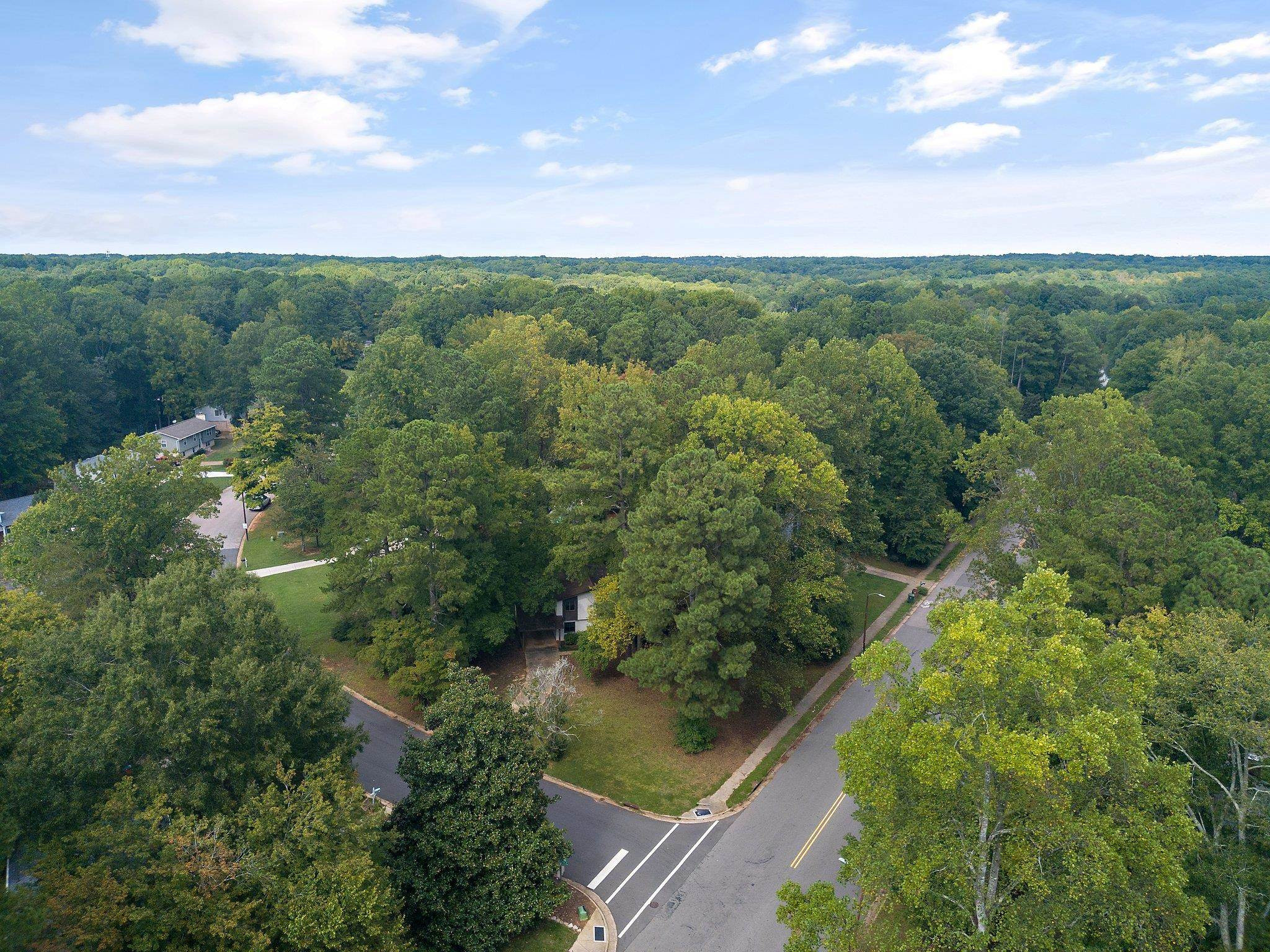 1307 Brookgreen Drive Cary, NC 27511 - Photo 8 of 26 an aerial view of residential houses with outdoor space and trees