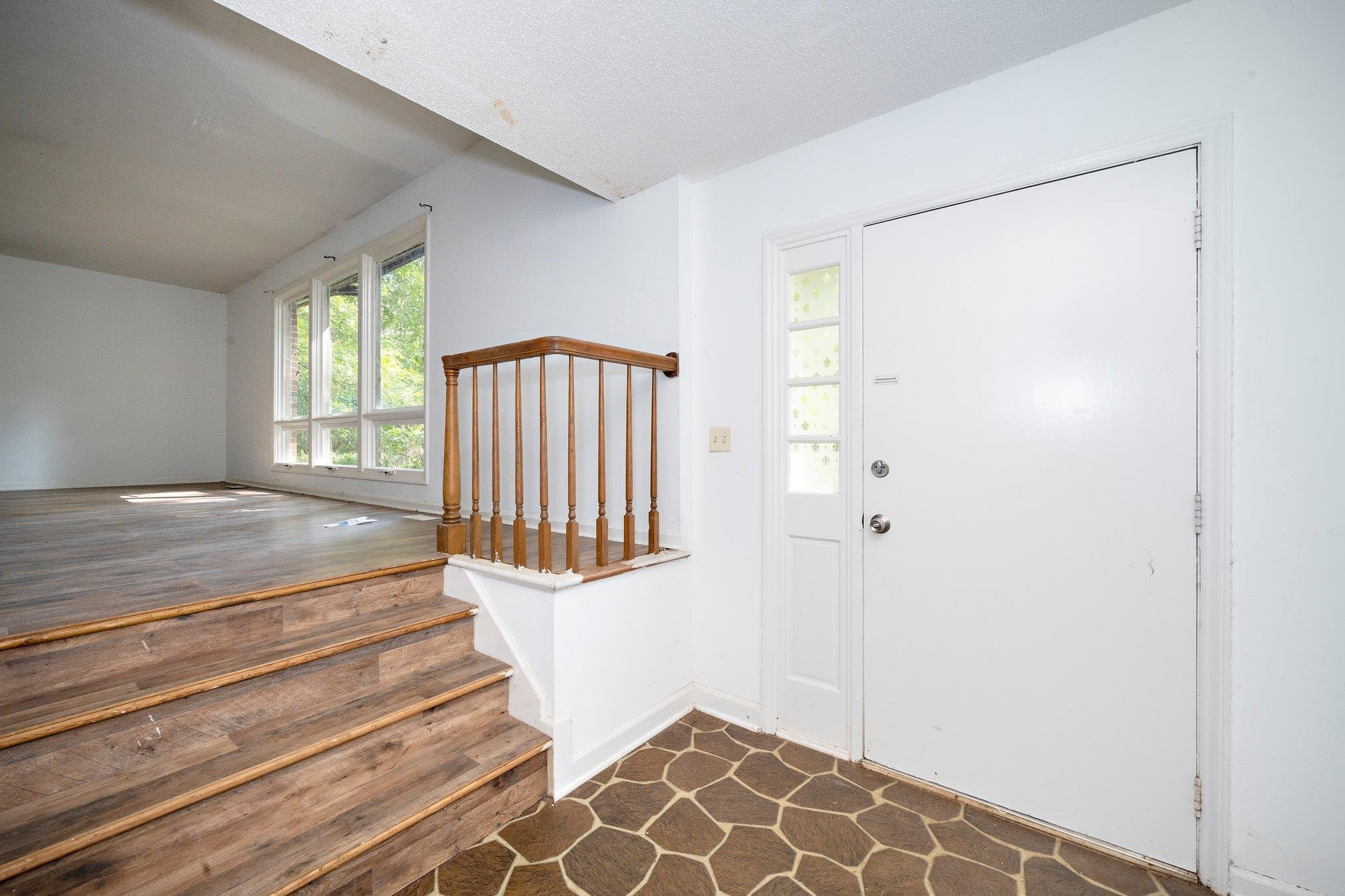 1307 Brookgreen Drive Cary, NC 27511 - Photo 10 of 26 a view of a livingroom with wooden floor and a large window
