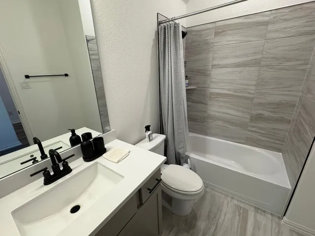 a bathroom with a sink toilet and shower