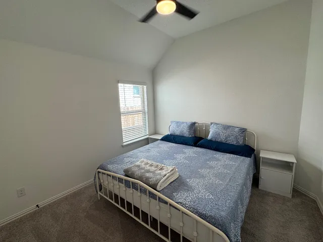 a bed sitting in a bedroom next to a window