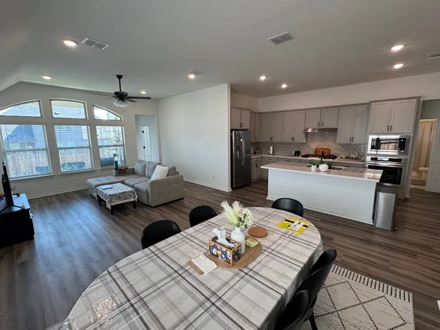 a living room with furniture and a wooden floor