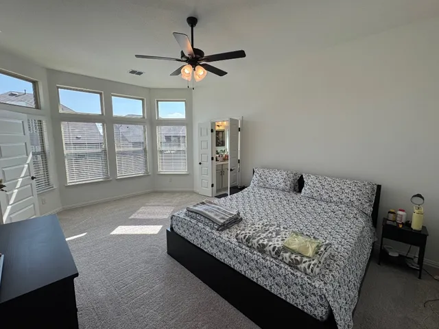 a living room with a bed furniture and a large window