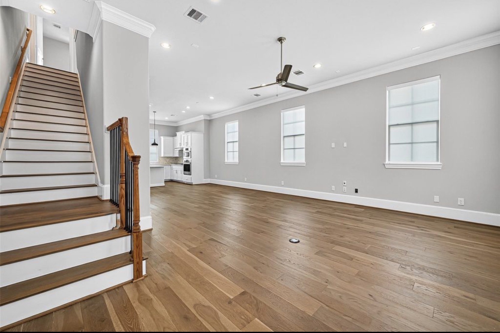815 Bringhurst Street Houston, TX 77020 - Photo 9 of 15 an empty room with wooden floor cabinet and windows